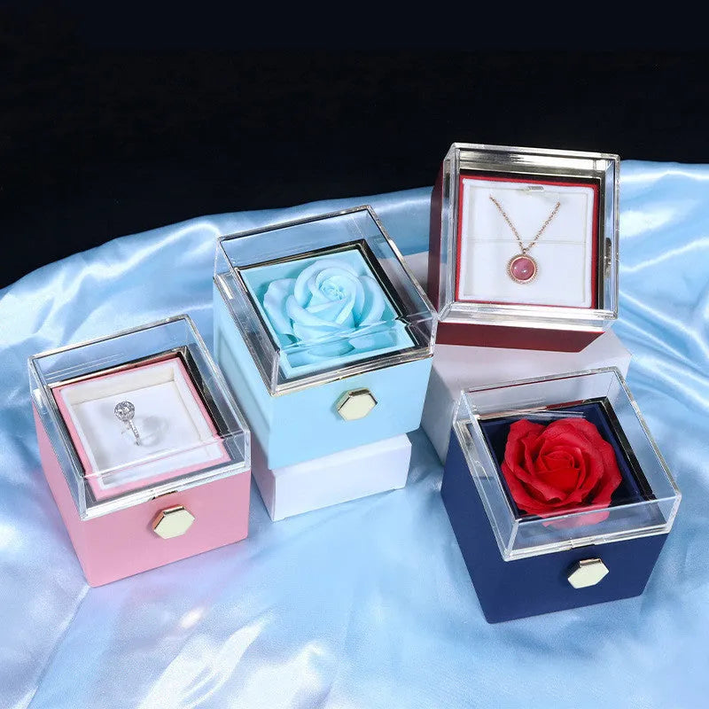 Rotating jewellery box with preserved red rose under acrylic cover and drawer open showing storage