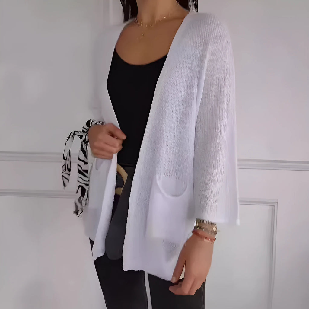 Women's waffle-knit cardigan coat in army green, showing texture and pocket detail.
