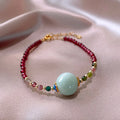 Women's garnet bracelet with aquamarine and tourmaline drop beads in Chinese Korean style design
