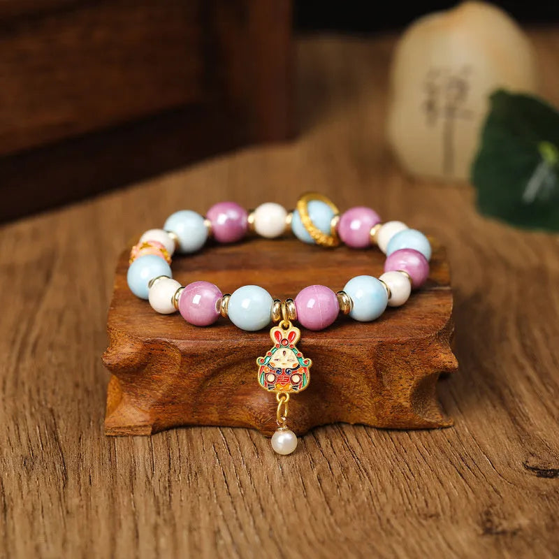 Gray ceramic bracelet with Lucky Rabbit design and adjustable cord on wrist