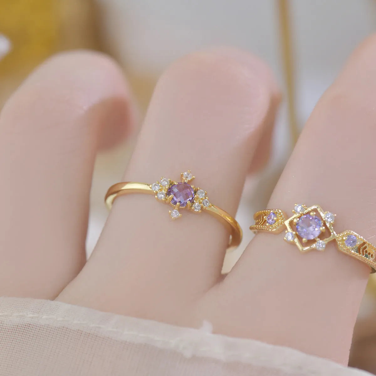French style geometric open mouth copper ring with purple zircon stones on a model's hand.
