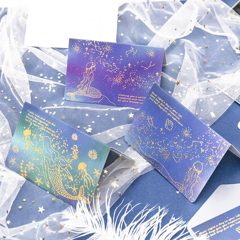 Set of three foldable sulfuric acid paper greeting card envelopes with bronzing, in celestial colours.