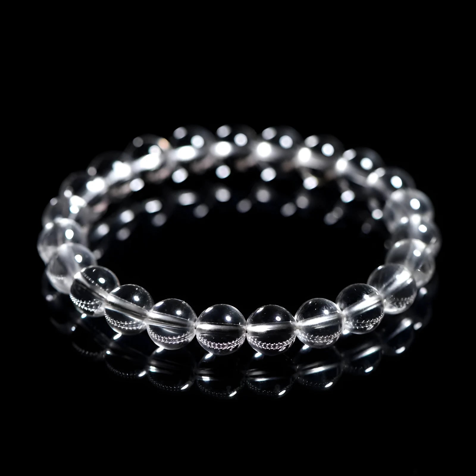 Natural old mine white crystal bead bracelet with geometric design on a wrist.