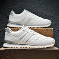 Men's black leather casual sports shoes with mesh lining and carved wing pattern design