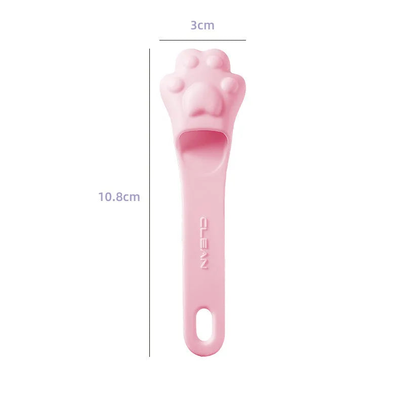 Silicone fingertip toothbrush for pets in pink, purple, and yellow, shown on a finger.