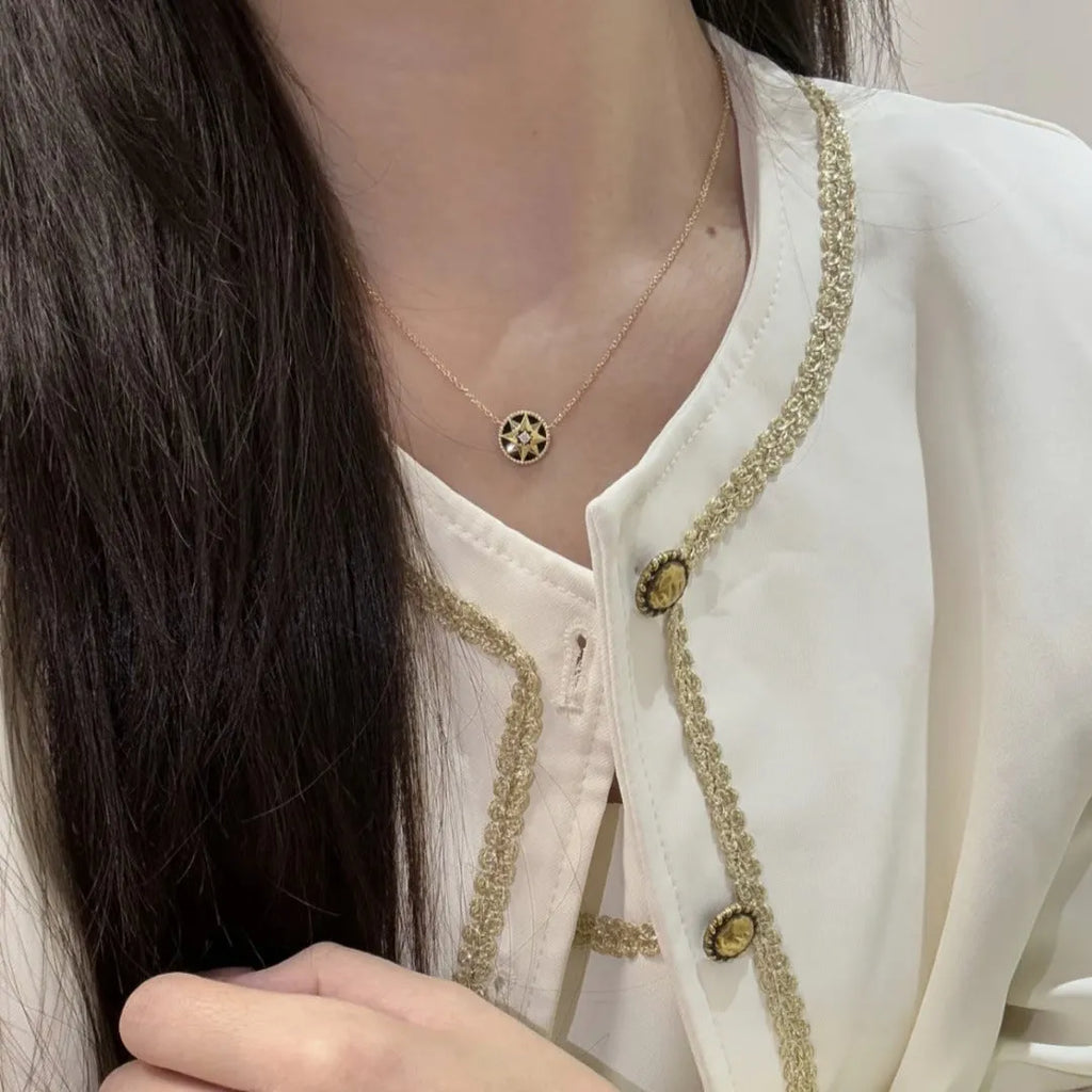 Women's compass necklace with round black agate inlay, geometric pendant, and curb chain in gold or platinum colour