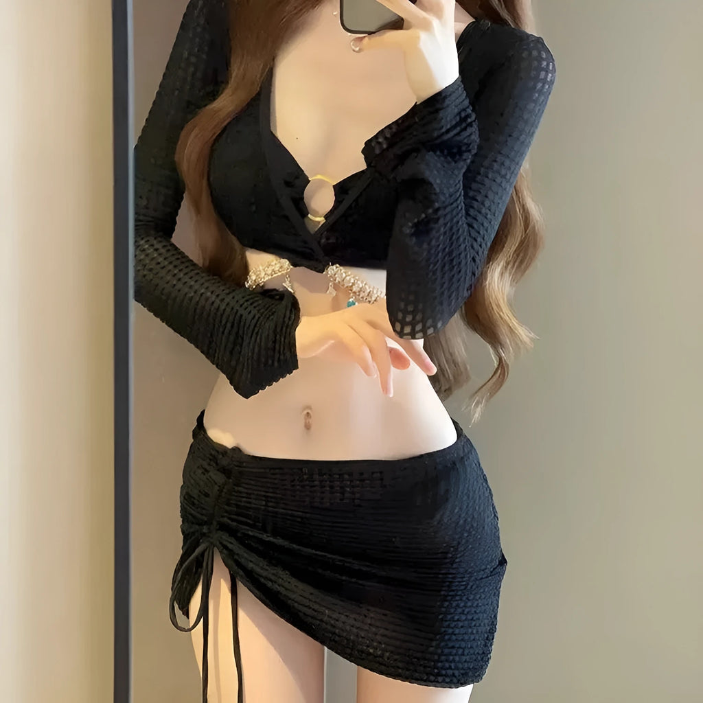Women's black long sleeve bikini swimsuit with split hot spring design on white background