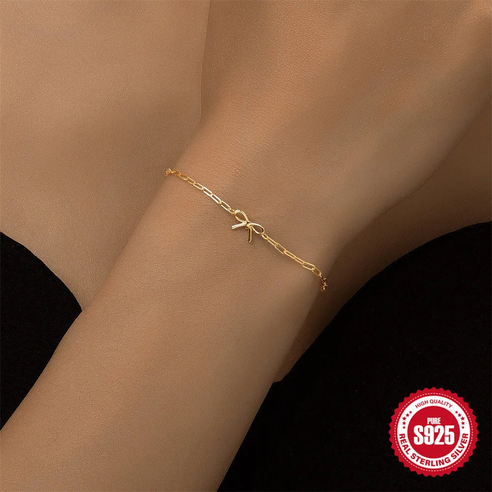 Gold plated sterling silver bracelet with geometric heart charm and clip chain clasp