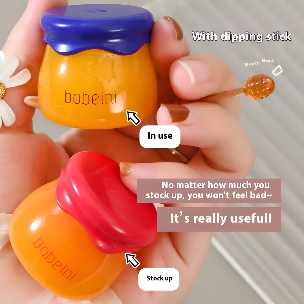 Honey pot style lip balm in 9g size with small application brush, shown in blueberry or pomegranate flavour.