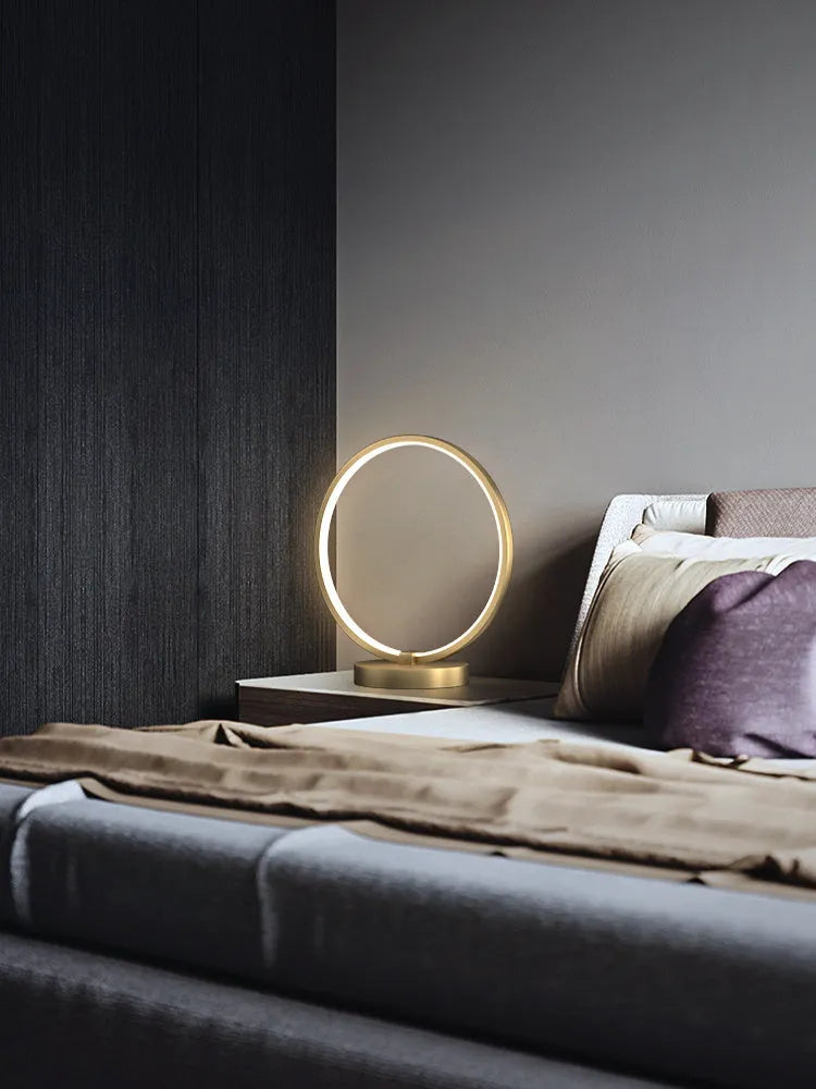 All copper Nordic style table lamp with tri-tone LED light, push button switch, on a wooden desk