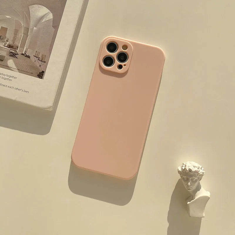 Frosted matte TPU phone back cover case for iPhone 14 in slate blue colour on a table.