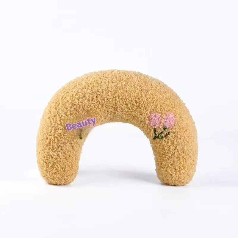 Blue and yellow cat sleeping mats with U-shaped neck pillows in moon and question mark shapes on a white background.