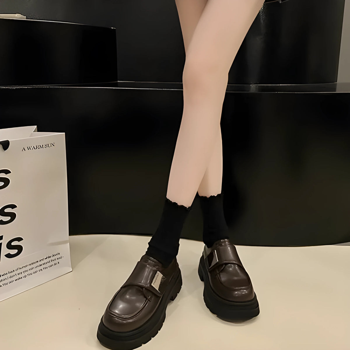Women's black chunky heel shoes with square heel and cross strap on a plain background
