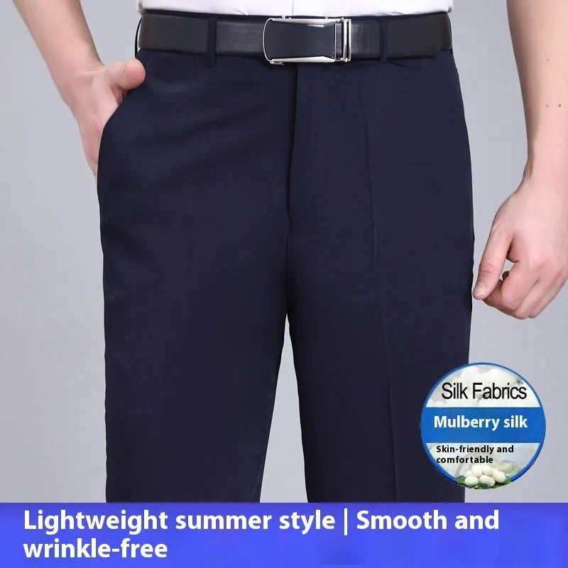 Man wearing dark blue straight-cut high-waist business trousers made from a mulberry silk blend.
