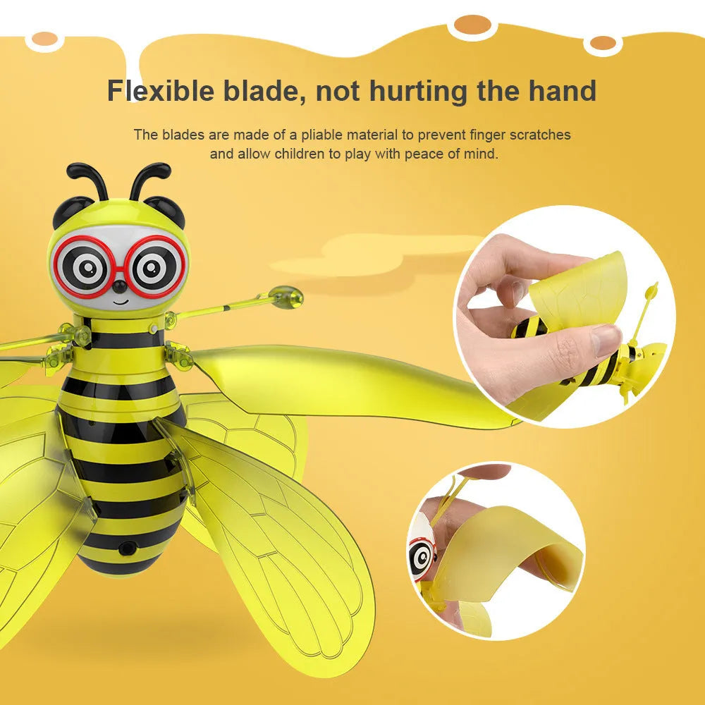 Yellow mini flying ball bee drone with infrared gesture sensing, ABS plastic body, and removable wings on a white background