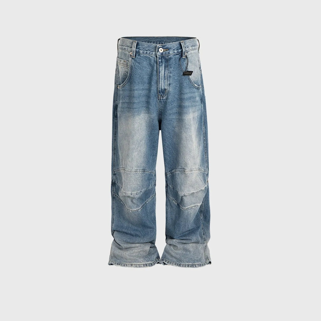 Baggy blue jeans with front pleats and a straight leg, shown in a washed denim finish.