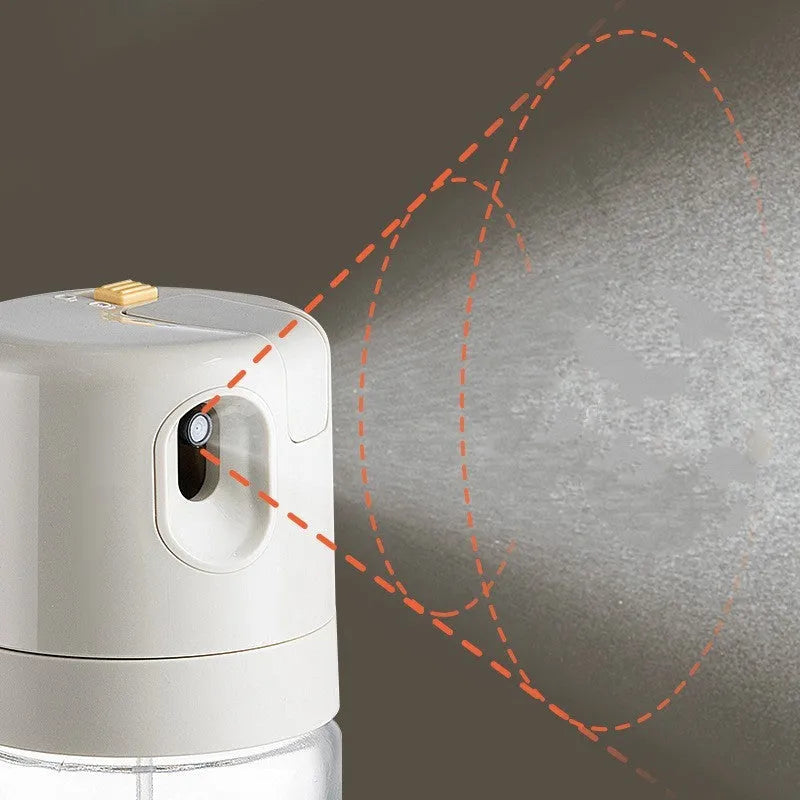 Warm grey glass oil spray bottle with a black lid and switch for selecting spray or pour mode.