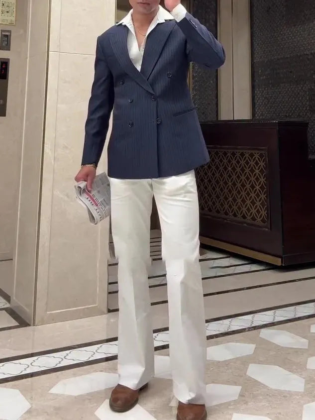 Men's striped double-breasted blazer on hanger showing regular length and structured front