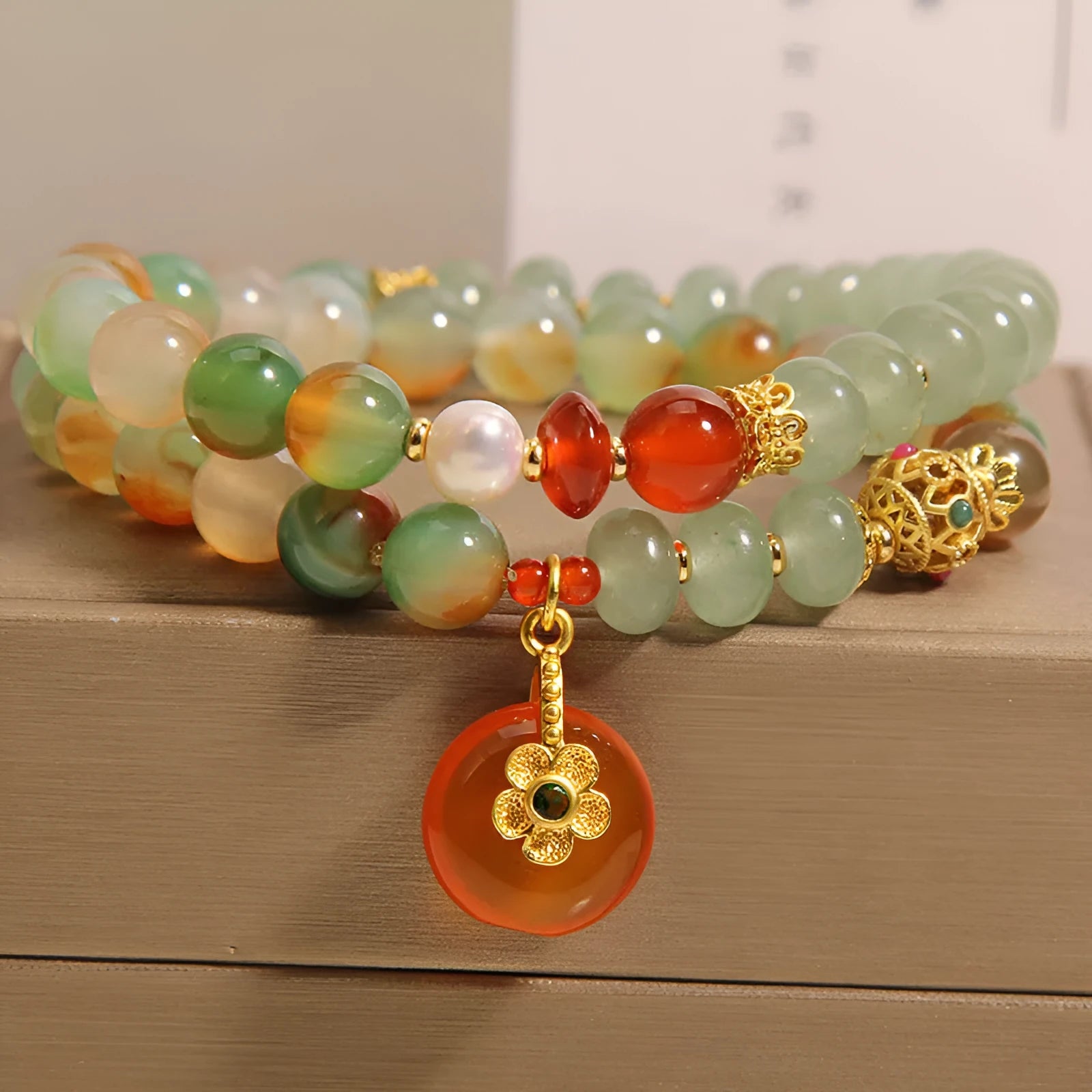 Peacock green agate double ring bracelet for women with safety buckle clasp and rhinestone details.