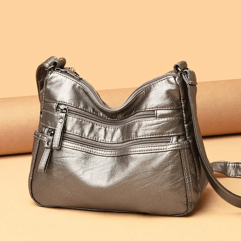 Real washed leather crossbody bag in solid colour with soft handle and slit pocket