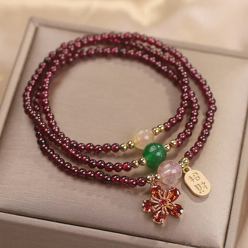 Crystal bracelet for women in pomegranate red cherry blossom colour with sequin details.