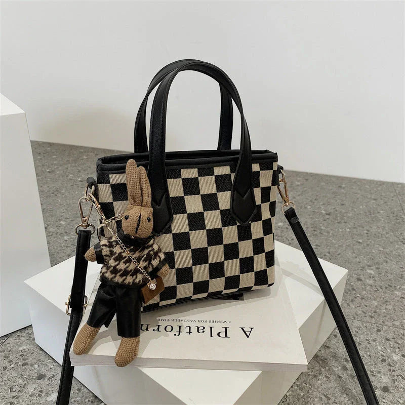 Stylish houndstooth shoulder bags in various colors, featuring a spacious square shape, adjustable strap, and classic checkerboard pattern.