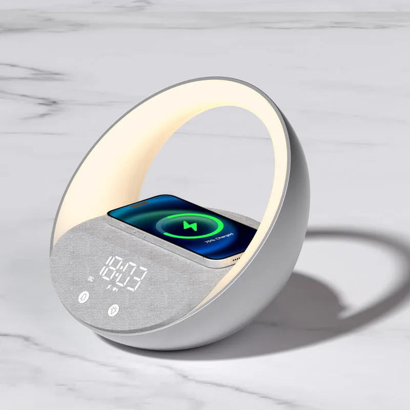 Beige multifunctional wireless charger clock with Bluetooth speaker and LED wake-up light on a bedside table.
