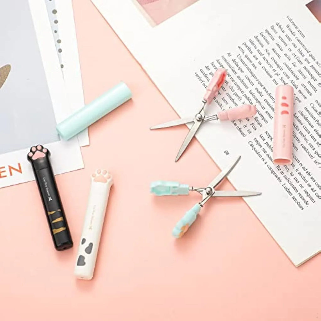 Small folding cat paw mini scissors with stainless steel blade in pink, white, black, and blue colour options.