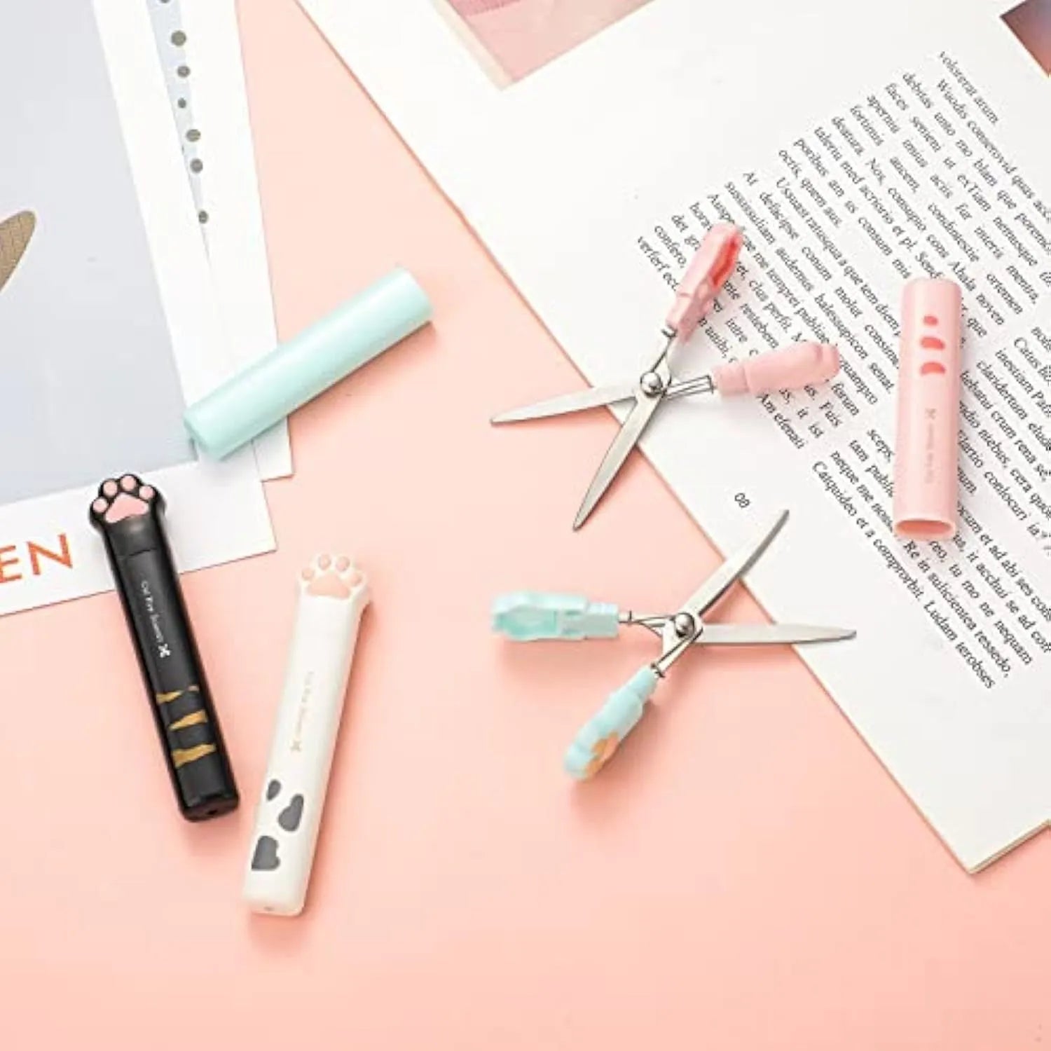 Small folding cat paw mini scissors with stainless steel blade in pink, white, black, and blue colour options.