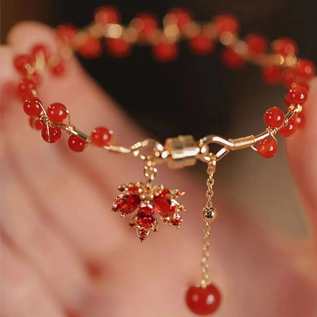 Red Chinese style magnetic bracelet with maple leaf and ginkgo leaf designs on alloy band