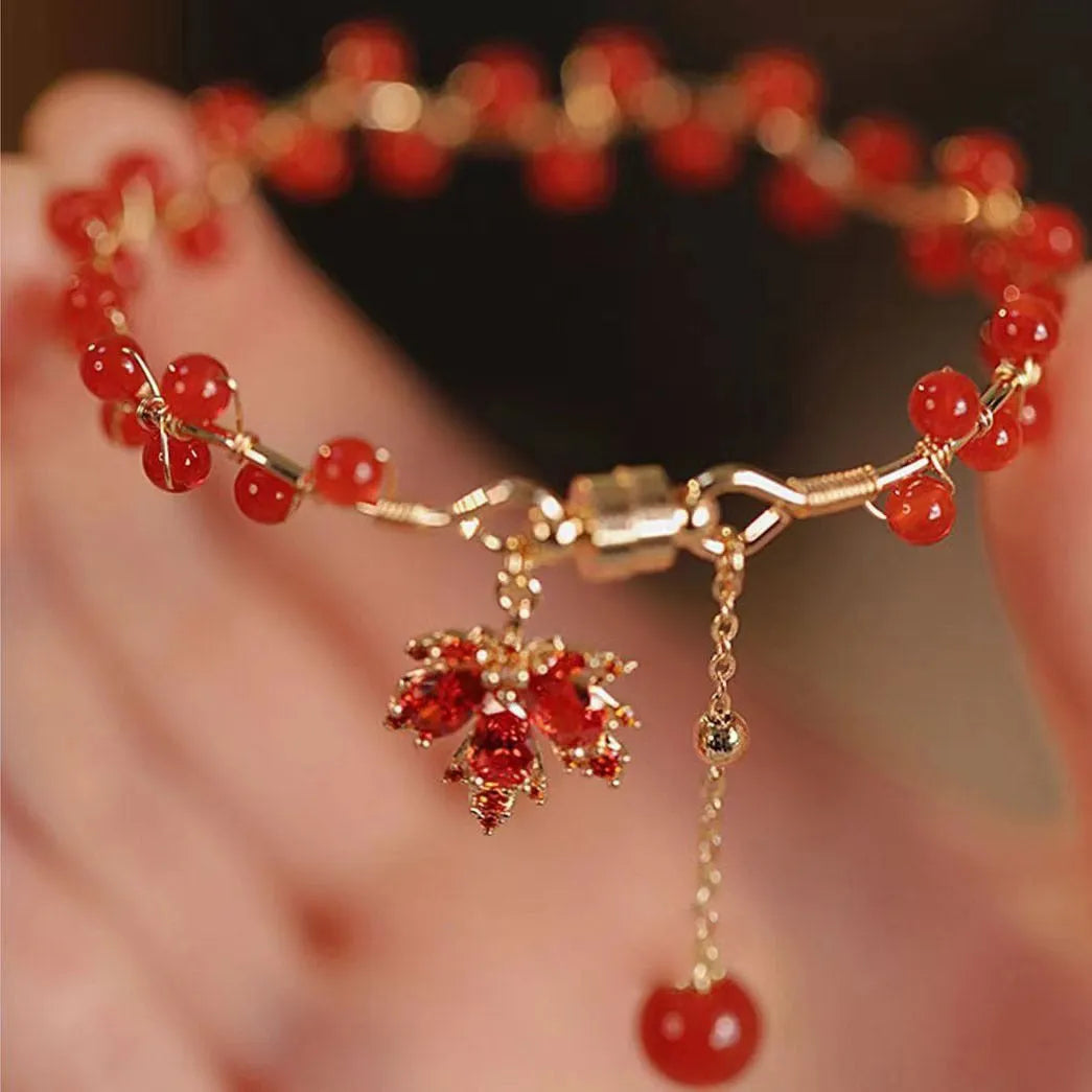 Red Chinese style magnetic bracelet with maple leaf and ginkgo leaf designs on alloy band