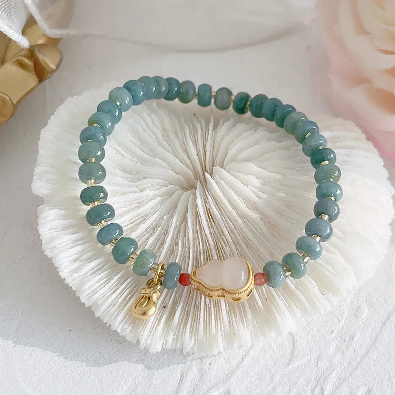 Natural blue water Hetian jade bracelet with carved gourd charm and engraved peace buckle