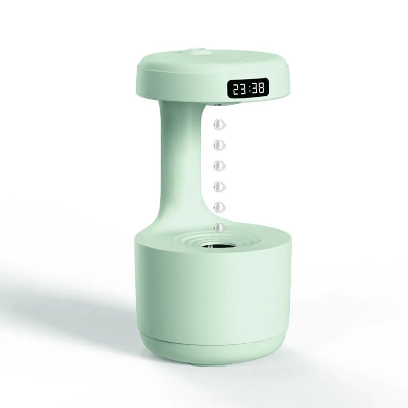 White anti-gravity levitating humidifier showing water droplets flowing upward with cool mist output