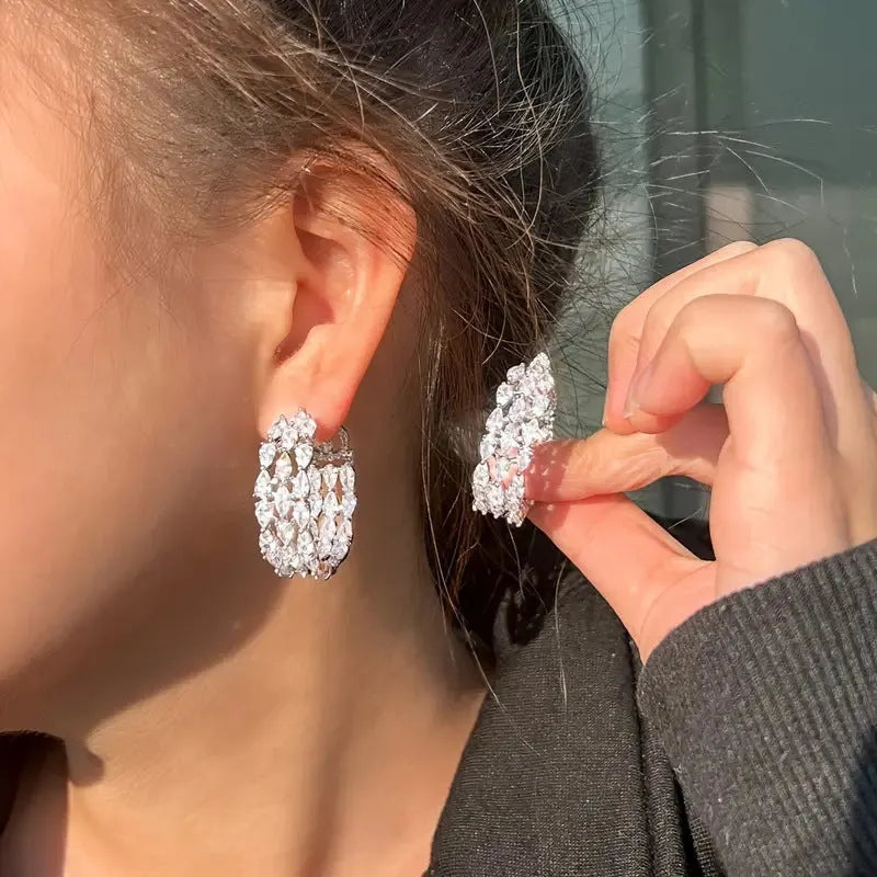 Pair of silver full diamond geometric electroplated copper earrings with threaded winding line design for women.