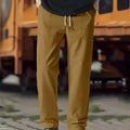 Men's light grey casual chino-style trousers made from polyester for spring and autumn wear.