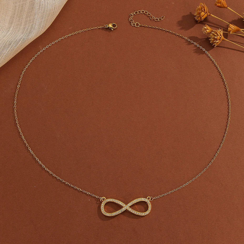Gold plated copper infinity symbol pendant necklace with sparkling diamond inlay and gold fine chain