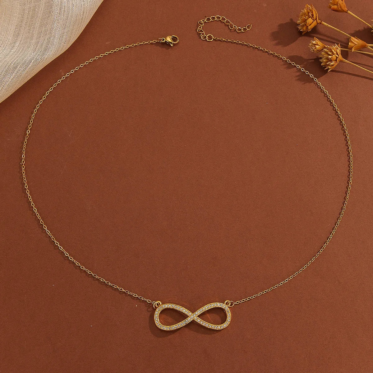 Gold plated copper infinity symbol pendant necklace with sparkling diamond inlay and gold fine chain