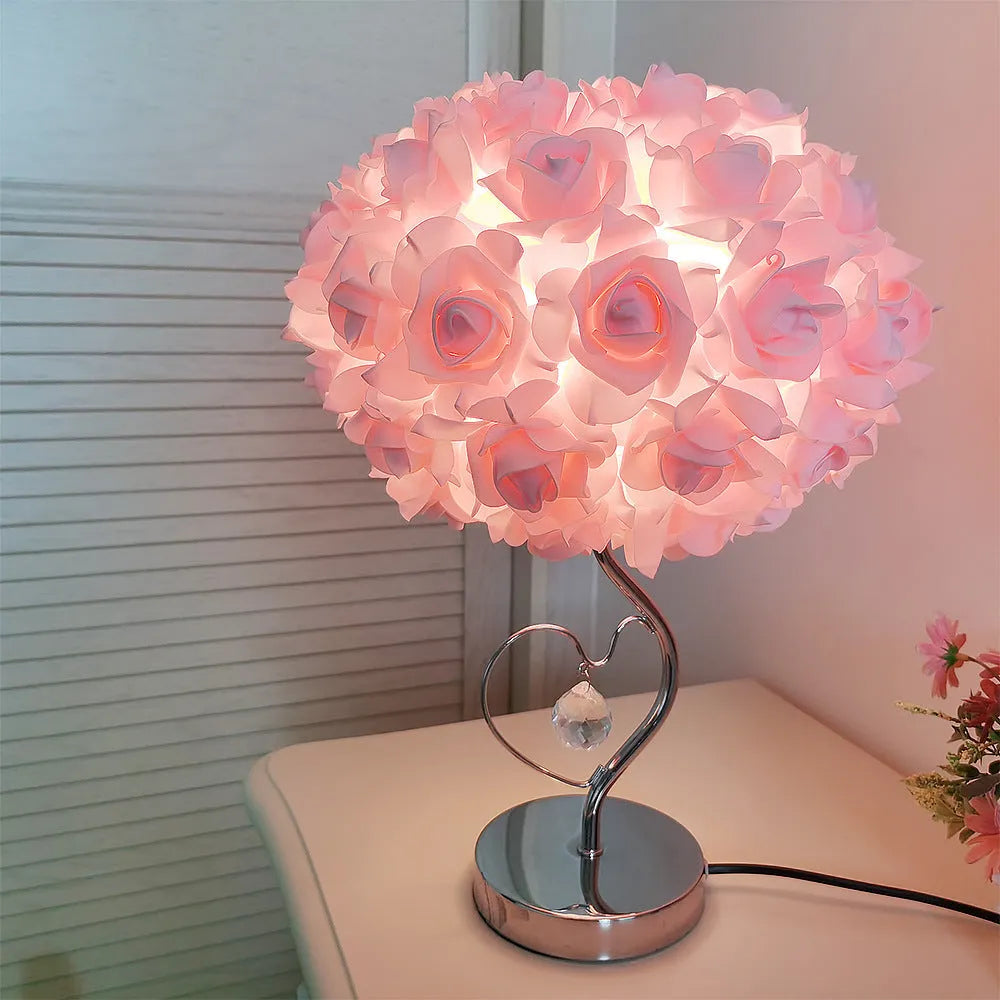 Heart-shaped crystal table lamp with metal holder, apricot colour, on bedside table