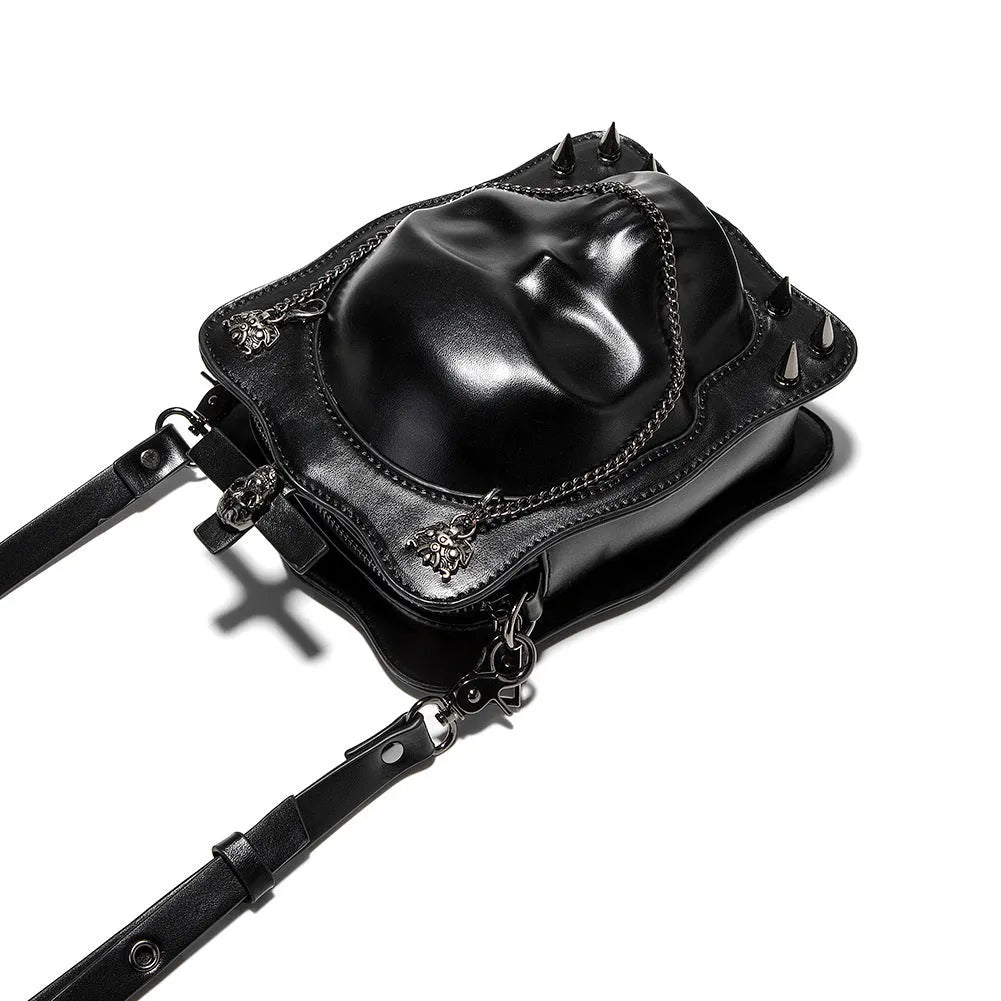 Black mini square crossbody bag with embossed skull design and metal chain strap