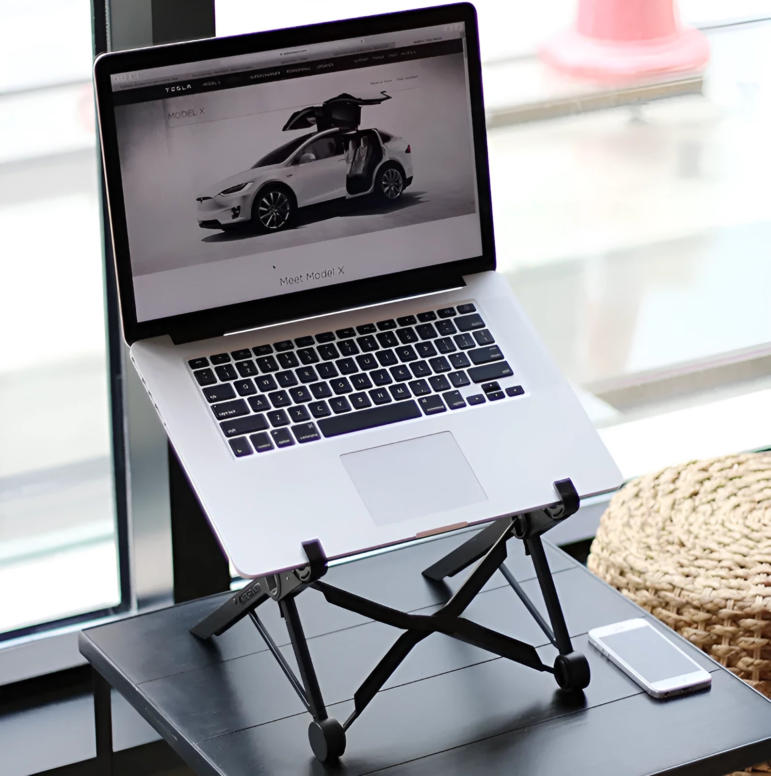 Black reinforced nylon folding laptop stand in open and closed positions