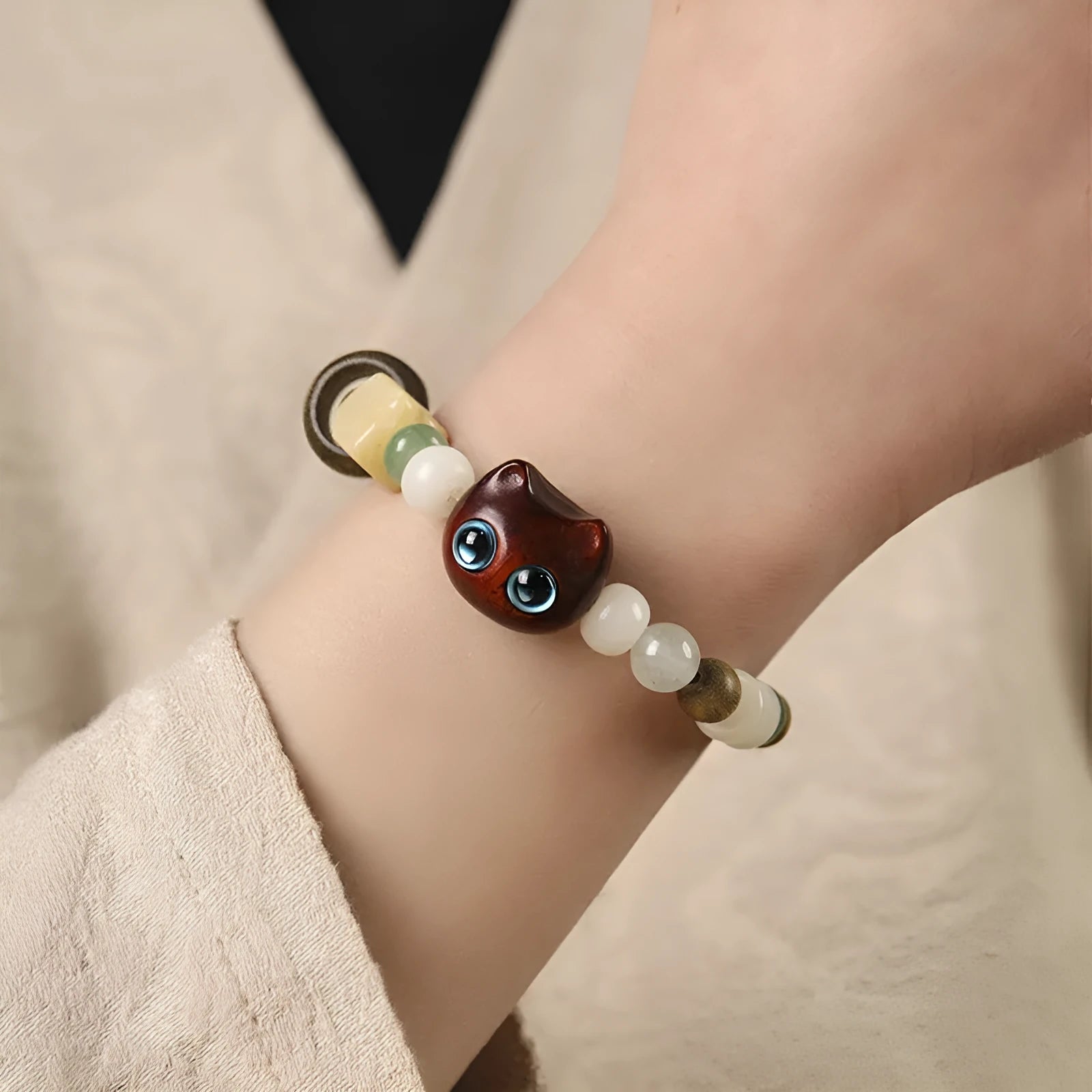 Hand-woven beaded bracelet with jade, bodhi and wood cubes and a wooden Sugar Cat's Paw charm.