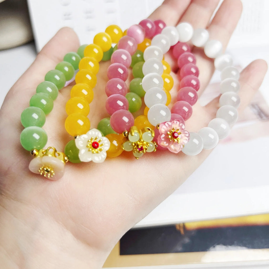 Women's handmade glass bead bracelet with floral design in green, pink, white or yellow