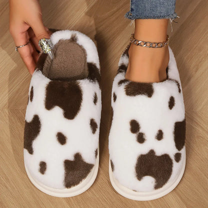 Cozy cow-print plush slippers with soft, fluffy material and non-slip soles for warm, comfortable indoor wear