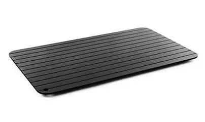 Black aluminium fast defrosting tray for kitchen use on a countertop