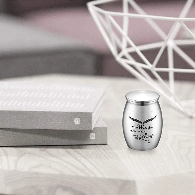 Custom stainless steel pet urn with mirror polish, precision thread seal and colour options in black, gold, photo colour or rose gold.