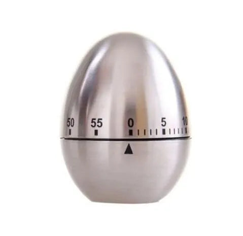 Stainless steel egg-shaped mechanical kitchen timer on a kitchen counter