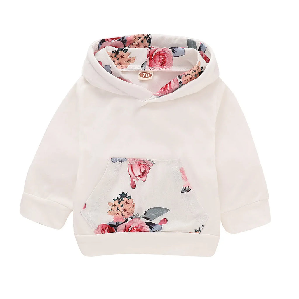 White cotton hooded tracksuit romper for a baby girl, showing long sleeves and full-length trousers.