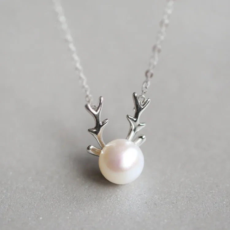 Small elk pearl pendant in copper with gold finish, front view against white background