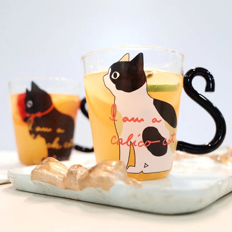 Adorable cat-shaped glass mug with a playful cat tail handle, perfect for coffee, tea, and juice lovers