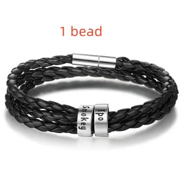 Personalized leather bracelet with engraved name charm for men, featuring a braided design and stainless steel beads